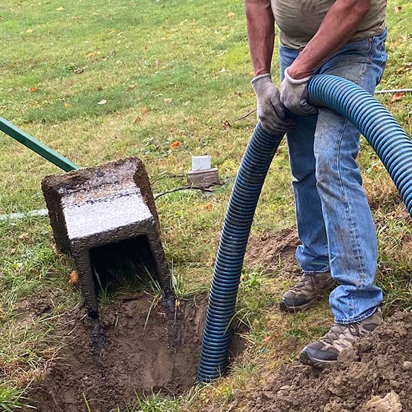 Man holding holes cleaning sewer out